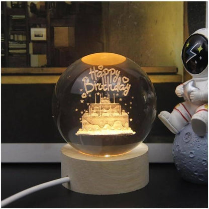 Galaxy crystal ball night light displayed on a wooden base